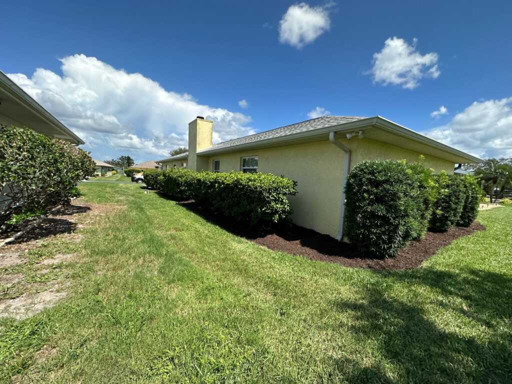 House with trimmed hedges surrounding it