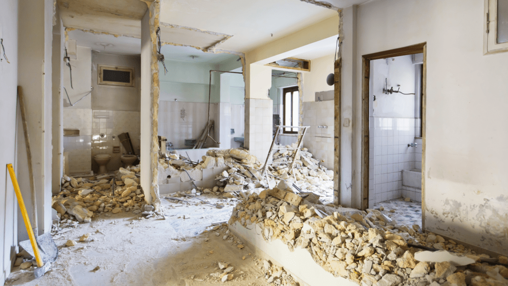 Room with walls demolished in piles on the floor