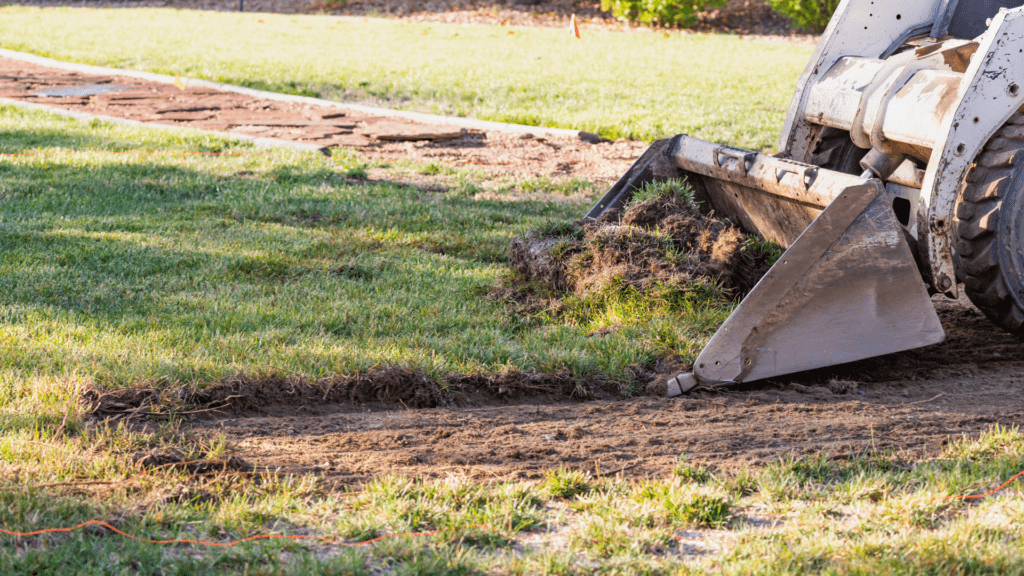 Bulldozer Preparing the ground by pulling up the grass off the property